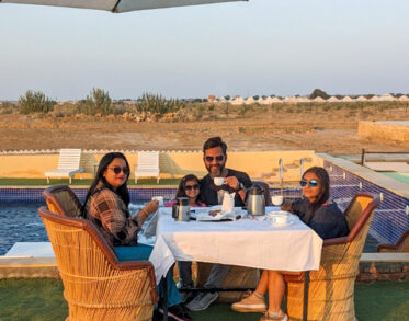 Morning conversations and warm coffee unfold beautifully beside serene pools and endless desert horizons