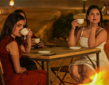 Share laughs and hot chai by a crackling bonfire as the desert twilight gently transitions into night