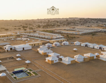 Luxury desert tents resort surrounded by golden Jaisalmer dunes