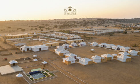 Luxury desert tents resort surrounded by golden Jaisalmer dunes
